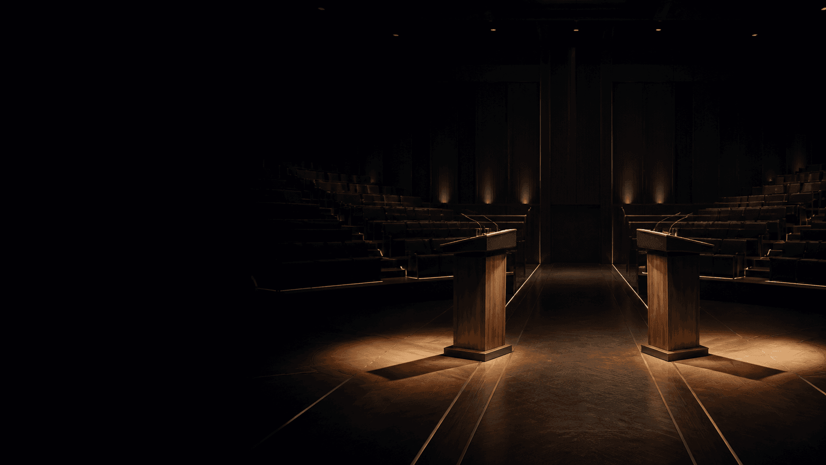 An empty debate chamber with two illuminated lecterns